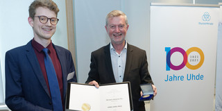 Mr. Rix presents the certificate he received.