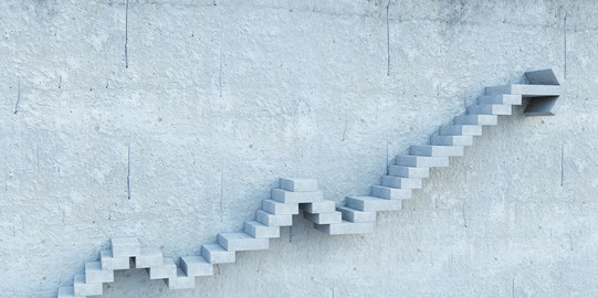 Stepped stairs protrude from a gray wall.